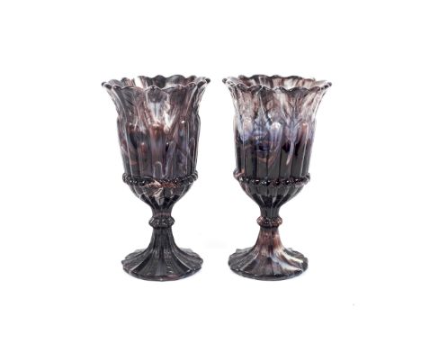 A pair of late 19th century pressed glass vases in marbled amethyst tint. Each with fluted and gadrooned bowl above gadrooned