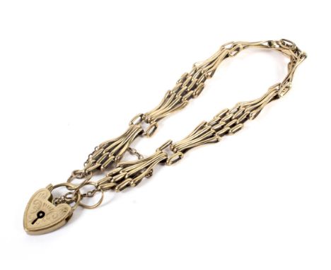 A vintage gold fancy gatelink bracelet on a heart-shaped padlock clasp. Stamped '9ct', 12g  Condition Report: Overall fair co