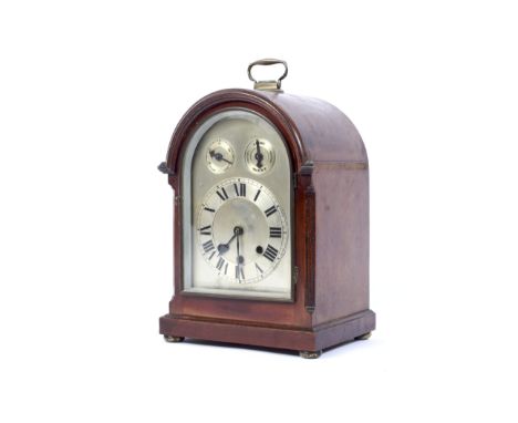 An early 20th century mahogany cased bracket clock. The arched silvered dial with Slow-Fast and Chime-Silent subsidiary dials