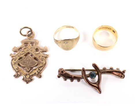 Two child's gold rings, a fob medallion and a brooch. Comprising; a small 22ct gold wedding band, Birmingham 1911, leading-ed