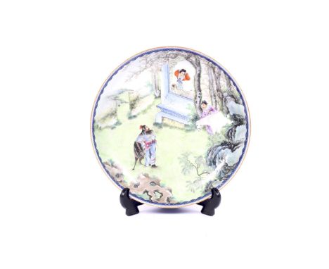 A Chinese porcelain famille rose enamelled circular shallow dish. With apocryphal underglaze blue six character reign mark fo