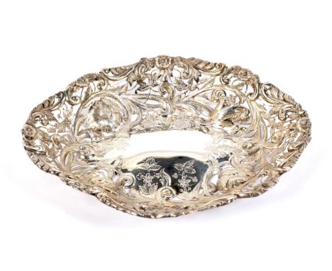 A late Victorian silver oval fruit basket. With pierced, engraved and chased sides embossed with flowers, leaves and scrolls,