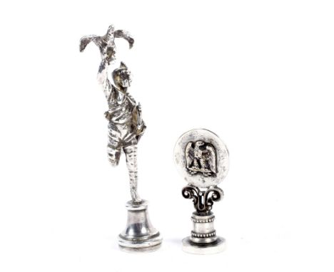 Two 19th century pipe tampers. The first modelled in silver as a depiction of one or Hera's archers holding a hawk aloft and 