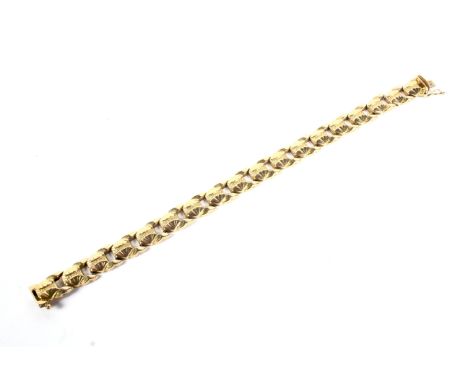 A vintage Italian gold bracelet. In the form of oval twin-fan decorated panels, the push snap with indistinct Italian marks a