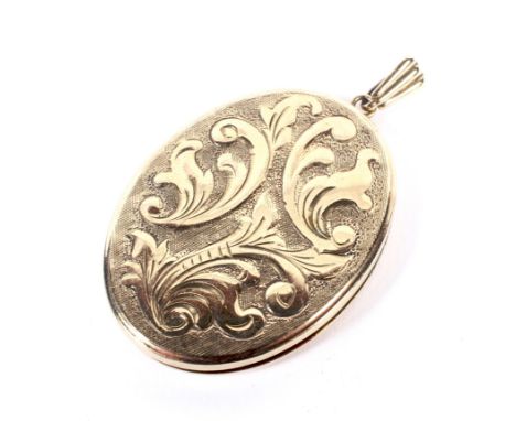 A vintage 9ct gold oval locket. Engraved with foliate scrolls on a matt ground, hallmarks for London 1966, approx. 43mm high 