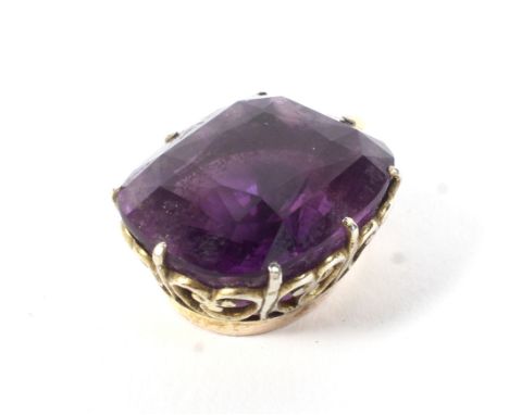 A vintage gold and cushion-shaped amethyst single stone pendant. Claw set in yellow on an open scrolling gallery, the bale wi