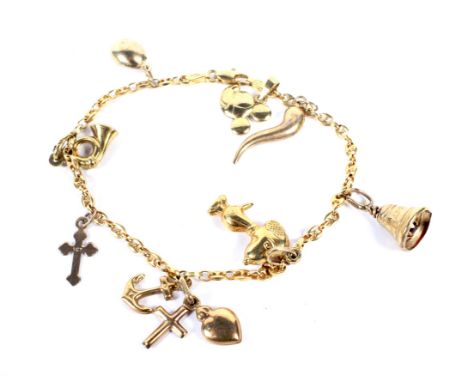 A vintage Italian gold anchor-link 'charm' bracelet. On a lobster-claw clasp, stamped '750', and hung with eight charms inclu
