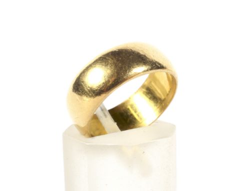 An Edwardian 22ct gold broad wedding band. Of shallow 'D' section, 6.7mm wide, hallmarks for Chester 1902, leading-edge size 