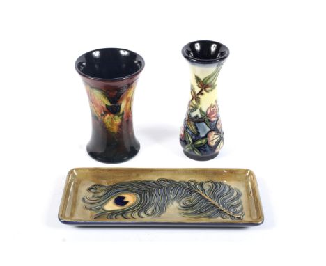 Three pieces of Moorcroft. Including: a Blackberries pattern waisted cylindrical vase (restored), a Peacock feather pattern r