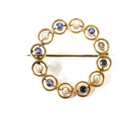 An early 20th century gold, sapphire and half-pearl open circlet brooch. Alternately set with round mixed-cut sapphires and h