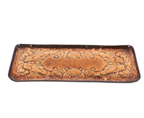 A Newlyn Arts and Crafts copper rectangular tray with fish decoration. Embossed with dish, waves and shells centred by a cart