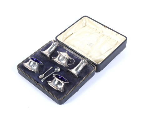 A silver five piece cruet set, in a case. Each of tapering form on a square base with re-entrant corners, comprising: a salt 