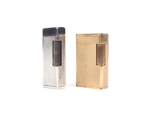 A Dunhill (Swiss) Rollagas silver-plated cigarette lighter and a Dupont (Paris) gilt lighter. The first engine turned, the se