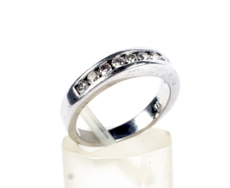 A vintage white gold and diamond half-eternity ring. The 11 round brilliants approx. 0.33cts total, all set within a white ch