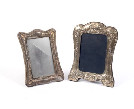 Two silver easel photo frames. One decorated with ribbons and a garlands of flowers, maker Carrs of Sheffield Ltd, Sheffield 