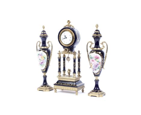 A 20th century clock  garniture. Gilt-metal and Sevres-style dark-blue ground porcelain mounted, the barrel-shaped clock with