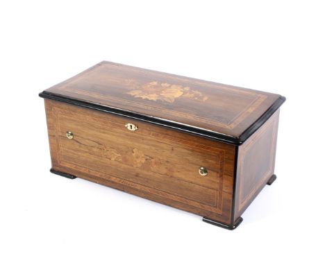 A late 19th century Swiss rosewood and marquetry inlaid music box. With lever operated cylinder, the hinged top and sides inl