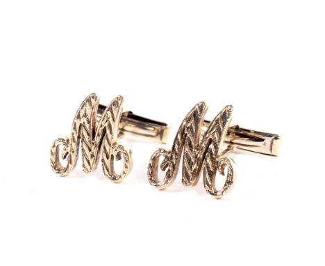 A pair of vintage 9ct gold baton-twist cuff links. Each in the form of an initial 'M', the hallmarks misstruck, probably Lond