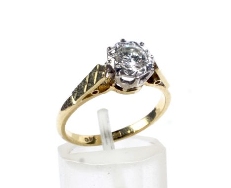 A vintage diamond solitaire ring. The round brilliant approx. 0.40cts, illusion set in white on a yellow gold 'D' section sha