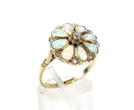 A vintage gold, opal and diamond flower-head cluster ring. Centred with a small old-cut diamond within a cabochon pear-shaped