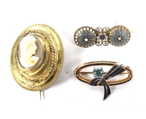 Three brooches. Comprising: a vintage bi-colour gold and pale blue zircon single stone oval brooch. Stamped '9ct', 5g gross; 