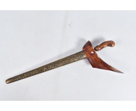 A TWENTIETH CENTURY KRISS DAGGER WITH ORNATE SCABBARD, this features a carved wooden pommel and an ornate scabbard, it is in 