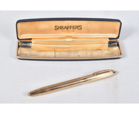 A GOLD COLOURED SHEAFFER FOUNTAIN PEN, engine turned design linear, screw on cap, with snorkel mechanism and a case missing i
