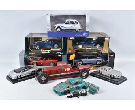 FIVE BOXED AND FOUR LOOSE MODEL VEHICLES,  boxed models include a 1:18 scale Maisto Aston Martin DB7 Vantage, numbered 36880,