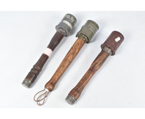 THREE INERT GERMAN STYLE STICK GRENADES, all three have wooden handles, the first has the words VOR GEBRAUCH SPRENGKAPSEL EIN