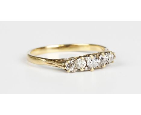 A gold and diamond five stone ring, mounted with a row of variously cut diamonds between scrolled shoulders, unmarked, weight