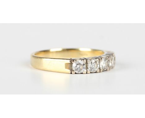 A gold and diamond five stone half-hoop ring, mounted with a row of circular cut diamonds, detailed '750', weight 5.1g, ring 