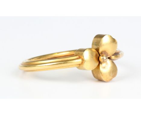 A Victorian gold oval bangle, the front with a trefoil shaped motif, unmarked, weight 17.2g, inside width 5.7cm, with a case.