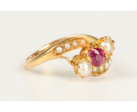 A gold, ruby, cultured pearl and imitation pearl ring in a crossover design, claw set with a cushion cut ruby between the two