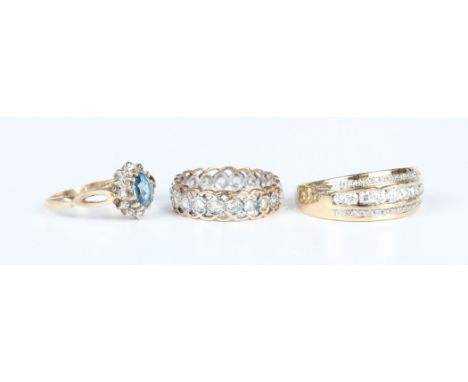 A 9ct gold and colourless gem set half-hoop ring, ring size approx R, a two colour gold and colourless gem set eternity ring,