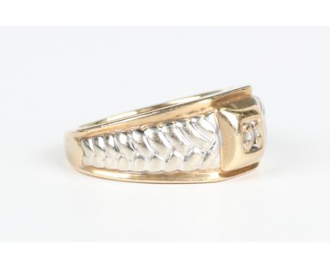 A 9ct gold ring, claw set with a circular cut diamond within a square surround between tapered herringbone formed shoulders, 