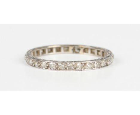 A diamond full eternity ring, mounted with circular cut diamonds, otherwise with engraved decoration, ring size approx S.Buye