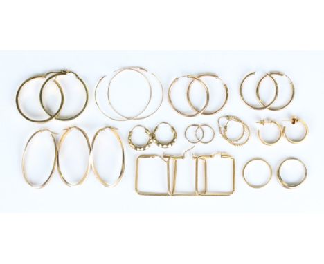 A pair of 9ct gold earrings in a twisted oval hoop shaped design, length 43cm, a similar earring, detailed '375', a pair of g