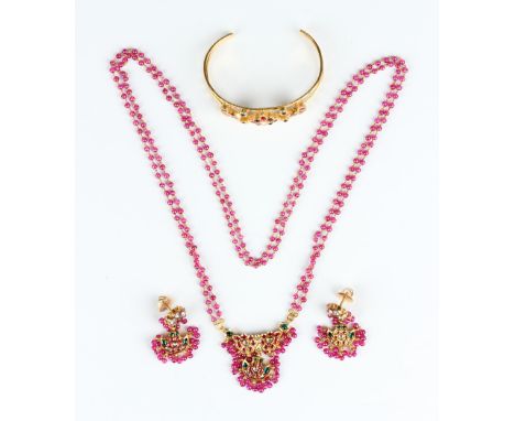 A gold, varicoloured paste and red glass bead suite of jewellery, probably Indian, comprising a bangle, inside width 6.2cm, a
