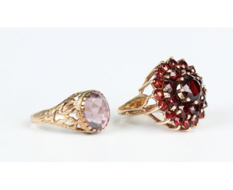 A 9ct gold and garnet circular cluster ring, Birmingham 1975, ring size approx L, and a 9ct gold ring, collet set with an ova