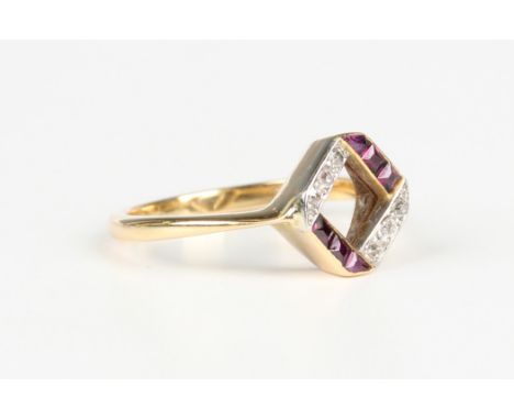 An Art Deco gold, ruby and diamond ring in a geometric design, mounted with calibre cut rubies and two rows of three cushion 