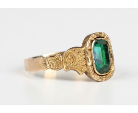 A Victorian gold and foil backed green paste ring with scroll engraved decoration to the shoulders, unmarked, weight 2.8g, ri