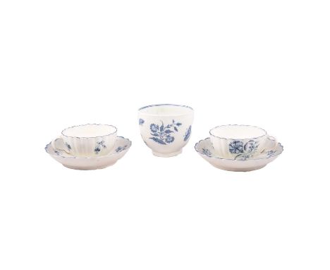 Two First Period Worcester cups and saucers, fluted bodies painted with a Carnation design, 13cm diameter; and a similar beak