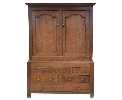 Joined oak linen press, basically 18th century, two arched fielded panelled doors over an arrangement of three short, two hal