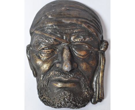 A vintage retro 20th century Bergamot Brass Works belt buckle in the form of a pirate wearing eye patch and bandana. Measures