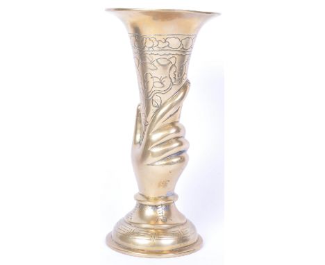 A vintage 20th Century brass trumpet vase. Circular flared top, floral decorated body being held. With a circular tiered base