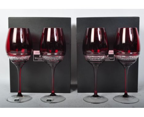 A set of four contemporary John Rocha for Waterford Crystal Red Voya ruby crystal wine glasses having hobnail decoration rais