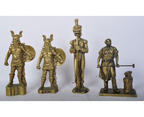 A collection of vintage 20th century brass figures to include a figure in the form of a blacksmith, a pair of viking warriors