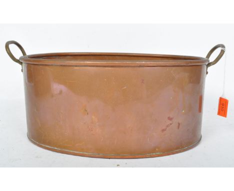 A 19th century Victorian copper planter of oval form with hoop handles and pipe rim. Stamped Made in England. Measures 32cm x