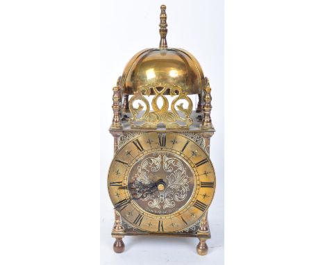 An early 20th century Smiths brass lantern clock. The clock having Roman numeral to the chapter ring with cathedral hands and