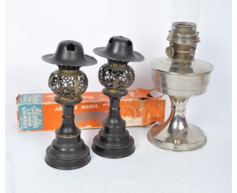 A collection of vintage 20th century lighting to include a pair of bronze tea lamps having pierced orb shaped holders over a 
